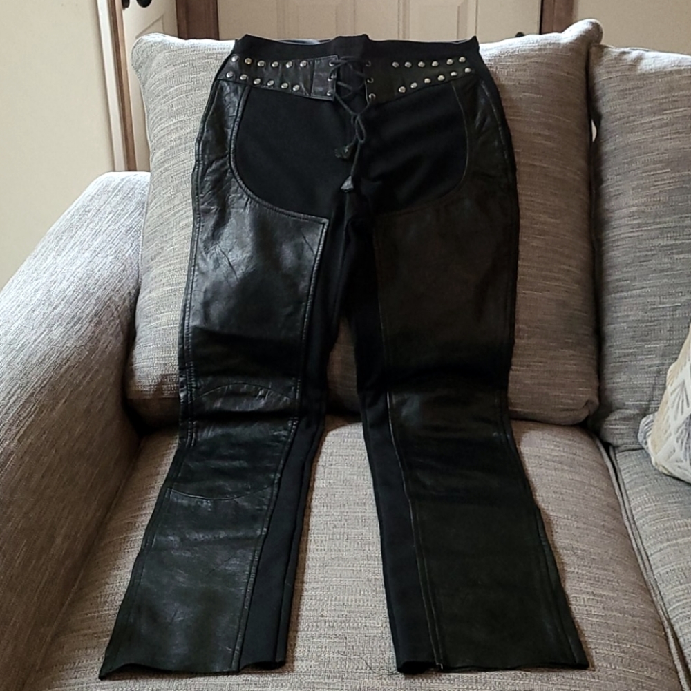 Leather and Spandex, zip in the back. Size large